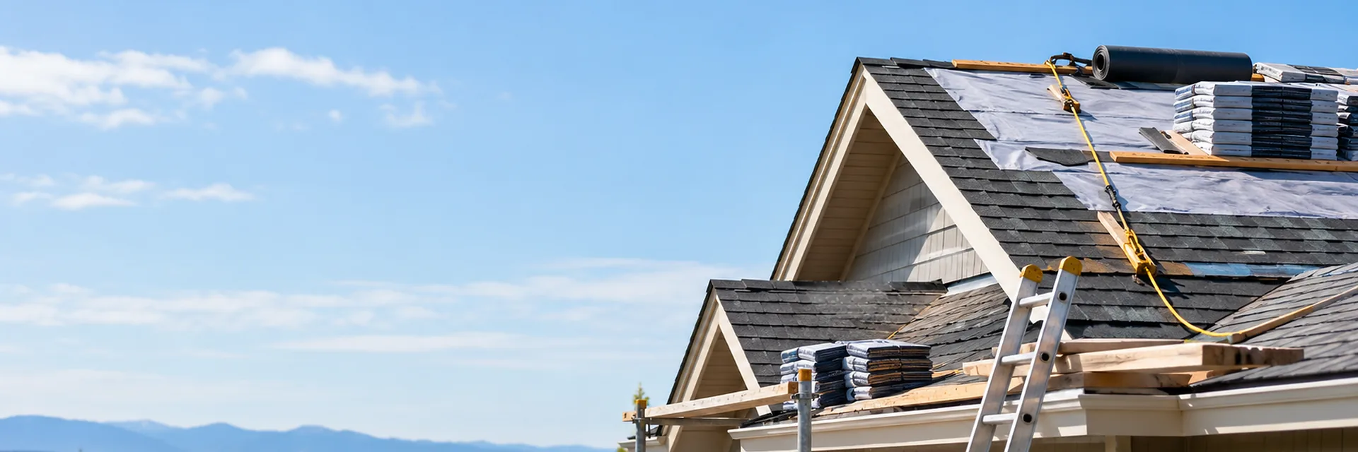 Roofers installing covering on a building roof — roofing contractor insurance