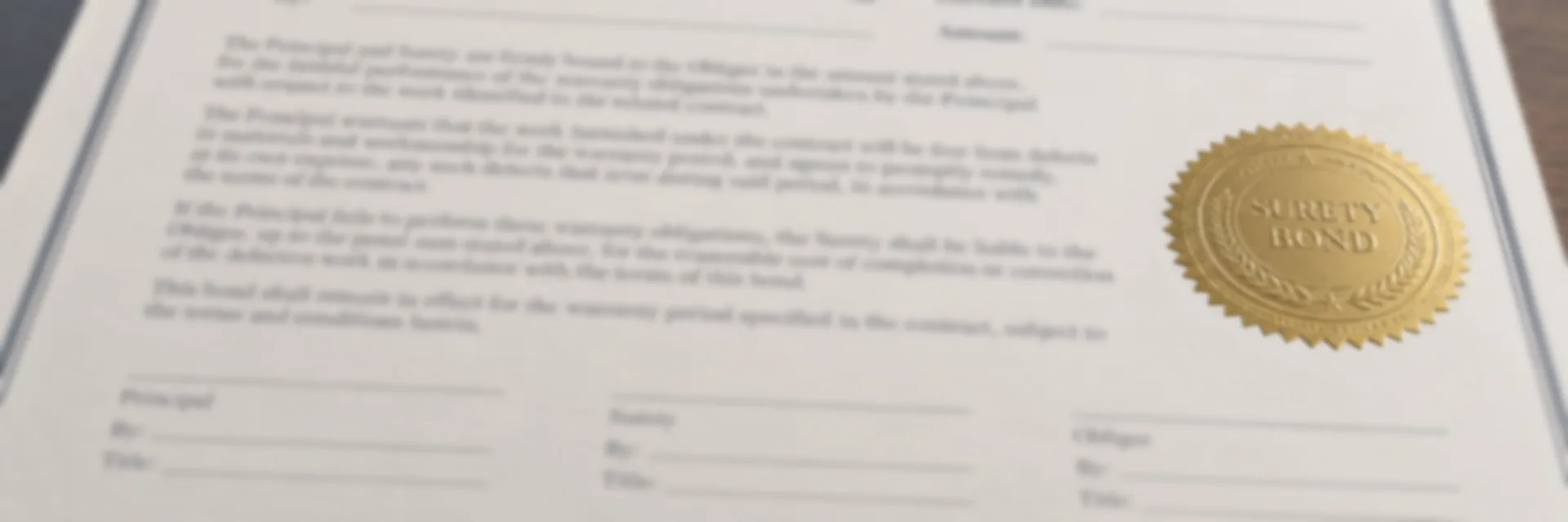 A warranty bond form on a leather desk pad with a gold surety seal, a newly built residential street behind it — warranty and maintenance bonds for completed construction work